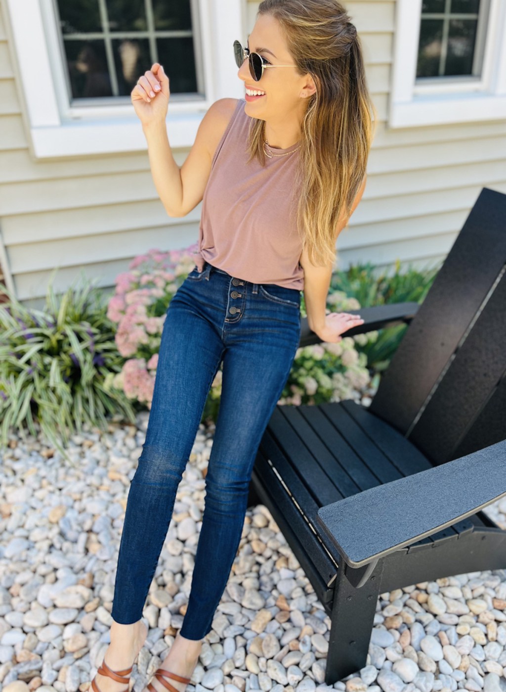 woman leaning on black outdoor chair