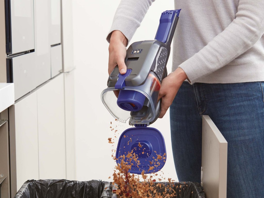 man opening cordless black & decker handheld vacuum to empty filter