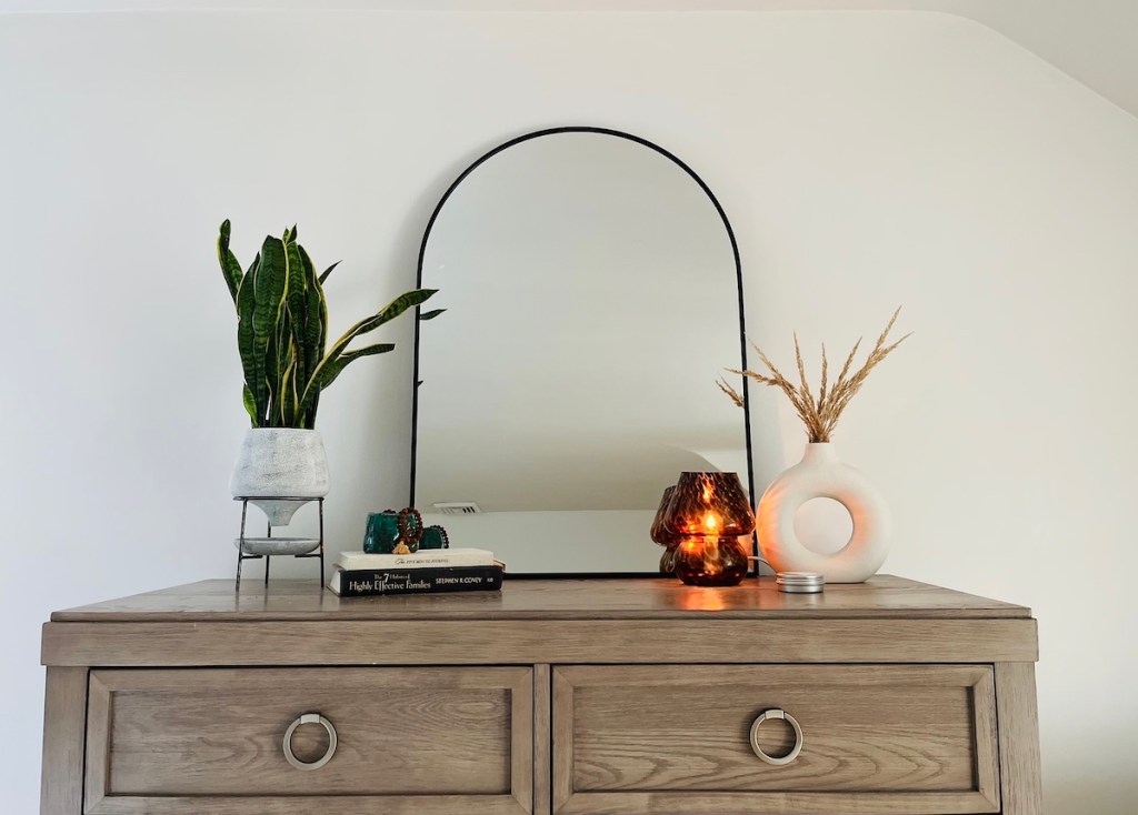 styled dresser with arch mirror and modern fall bedroom decor
