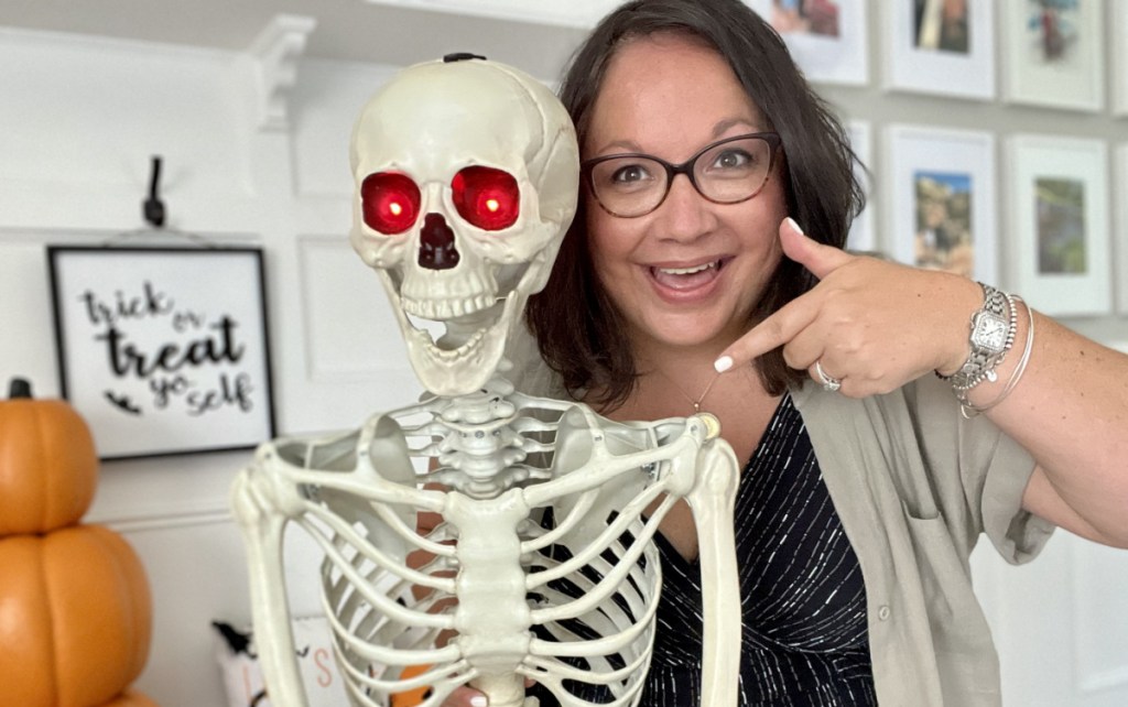 woman standing by posable skeleton 