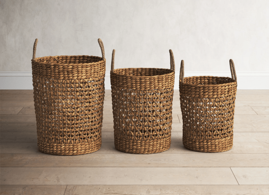A set of three woven baskets from Birch Lane on Wayfair displayed on a wood floor