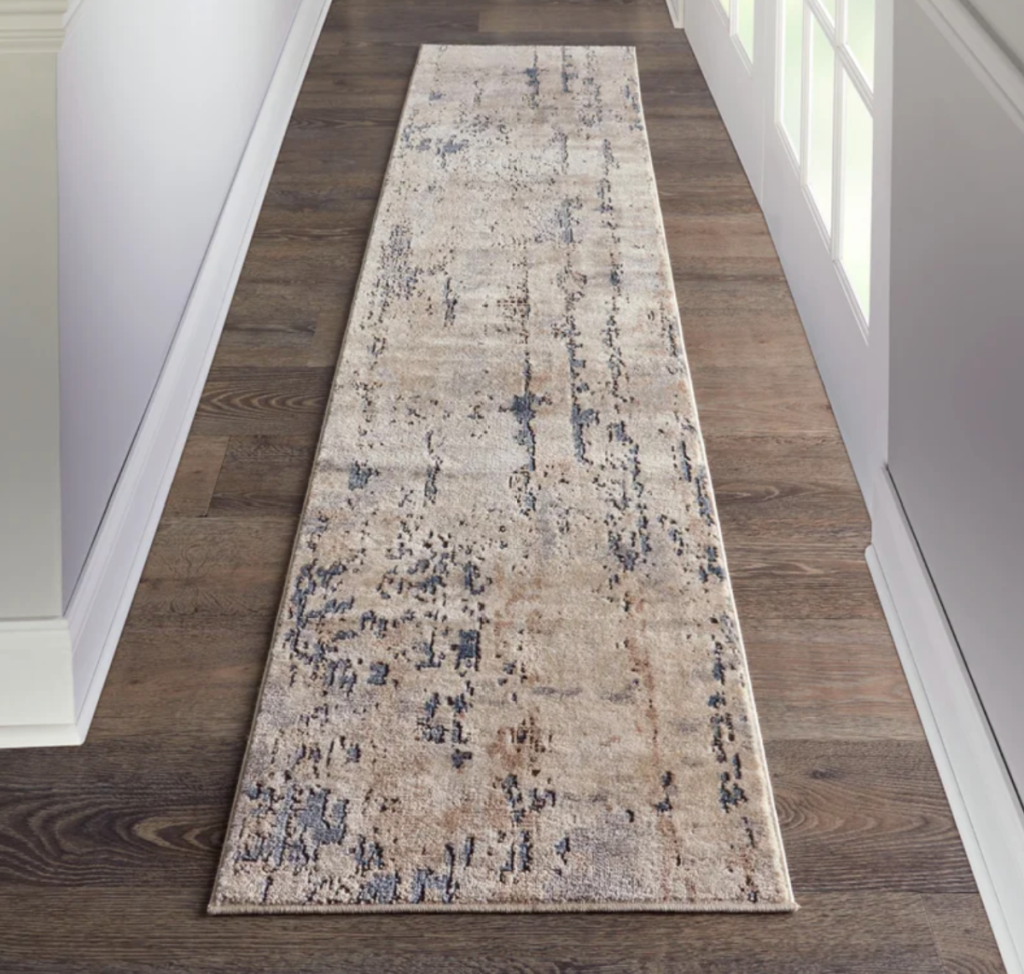 A hallway with the Addie Slate Gray Area Rug from Mercury Row