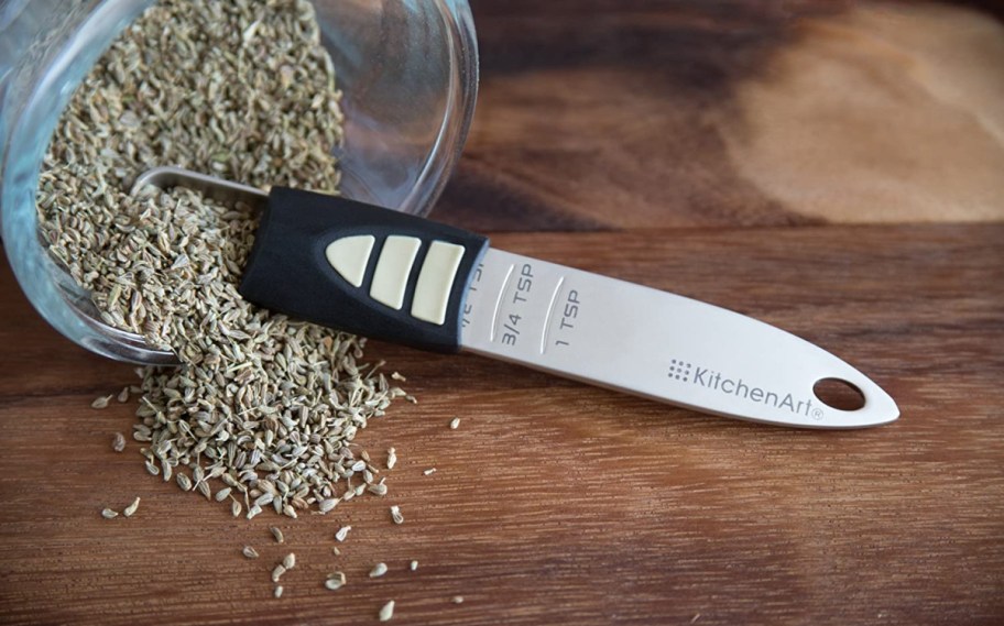 A kitchenArt Adjust-A-Teaspoon in a bag of spices