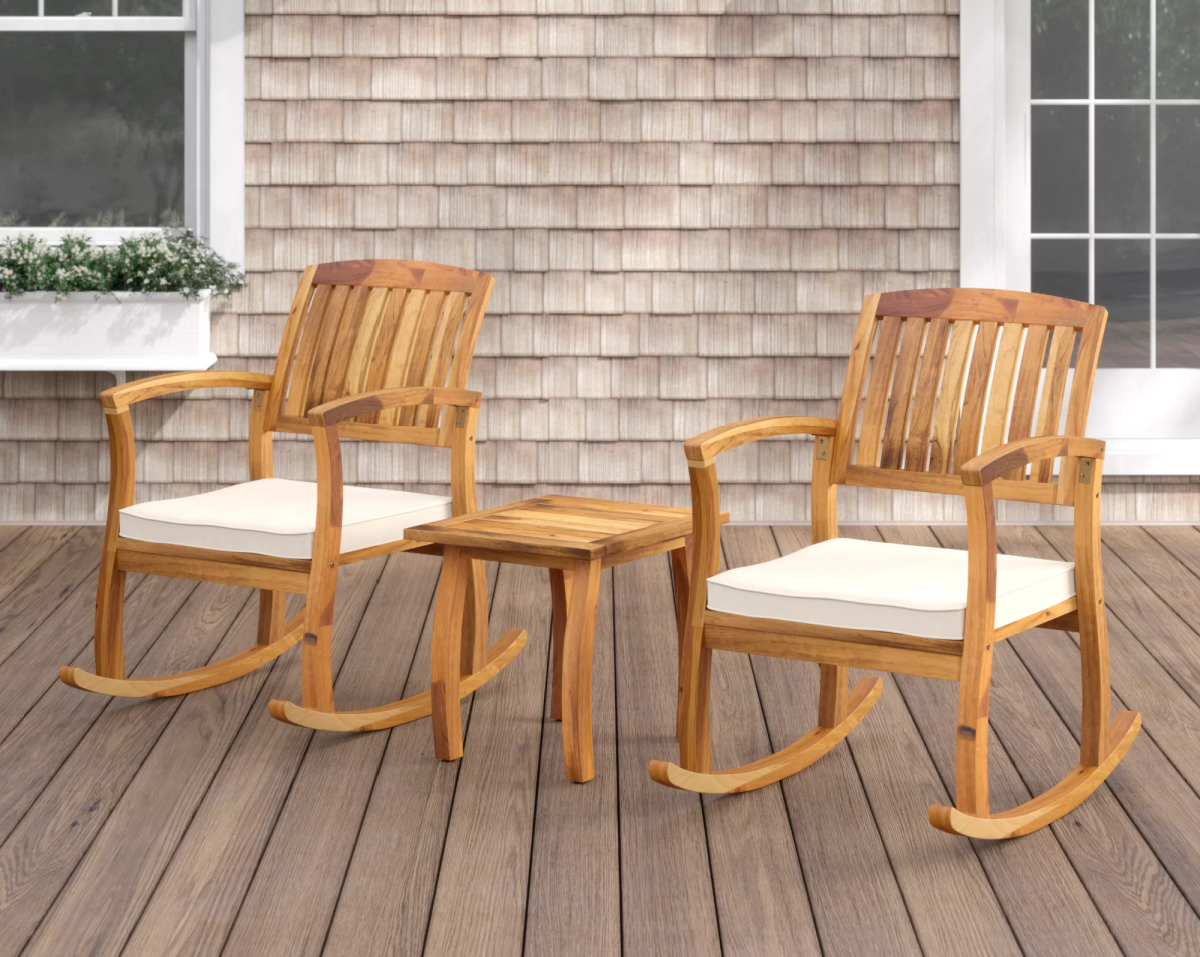 Wayfair furniture, including Two Brizio Solid Wood Rocking Chairs and a wood table displayed on a front porch