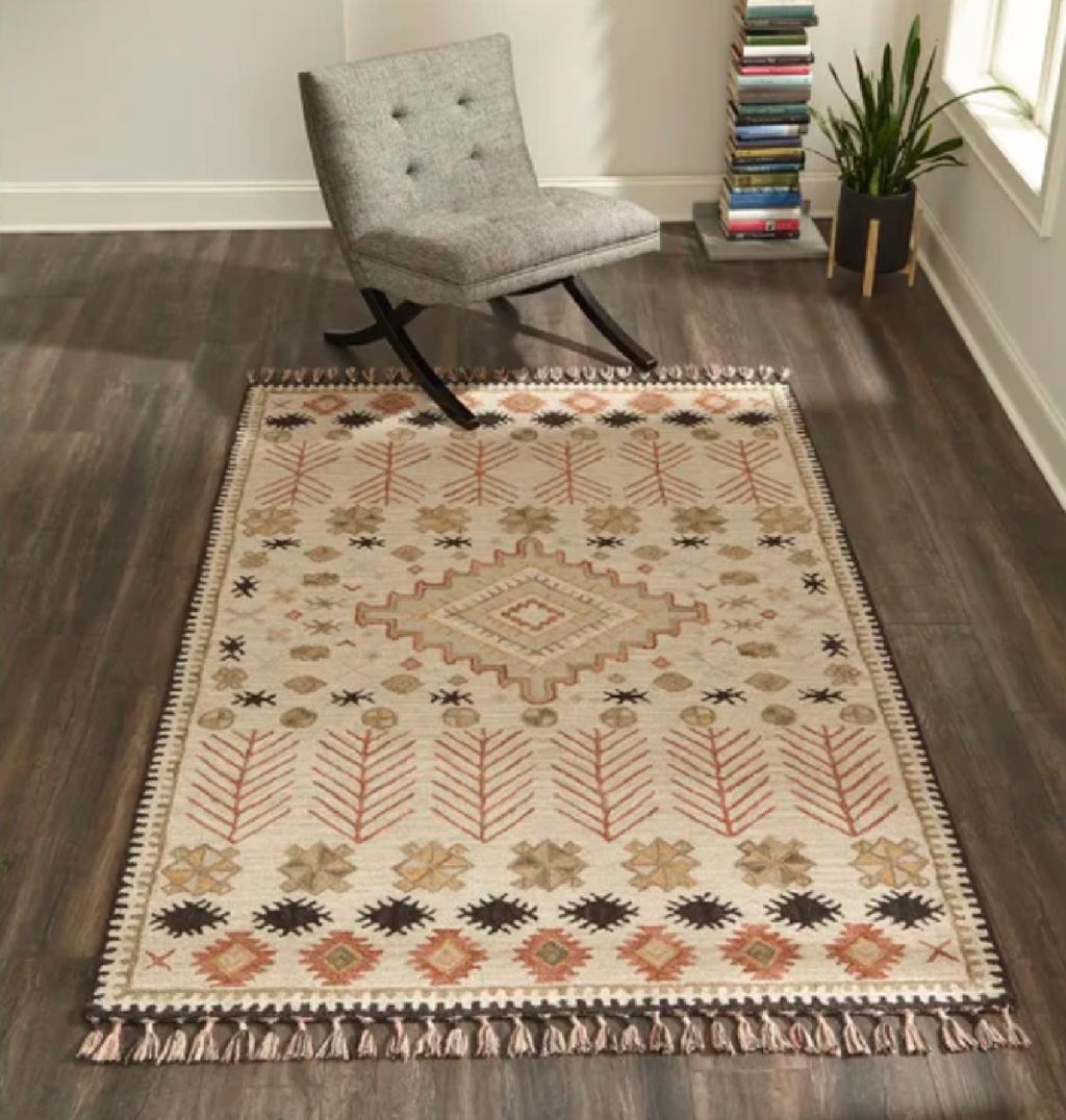 A southwestern wool area rug displayed on a study floor and available to purchase at the Wayfair Way Day event