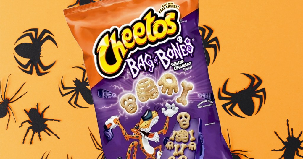 bag of halloween cheetos on orange background with spiders