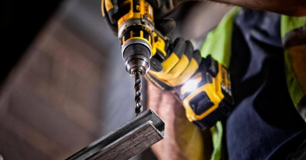 dewalt drill working into metal rod