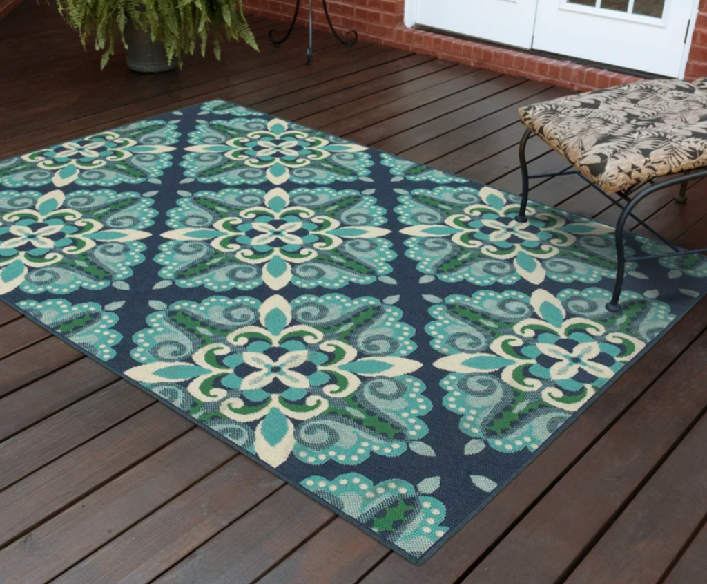 A deck with a blue and green Deltana indoor nad outdoor rug on it that was available to buy during Way Day