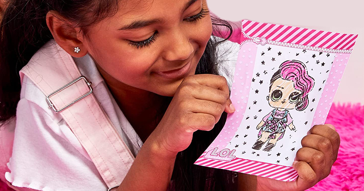 girl holding an lol surprise fashion plate drawing