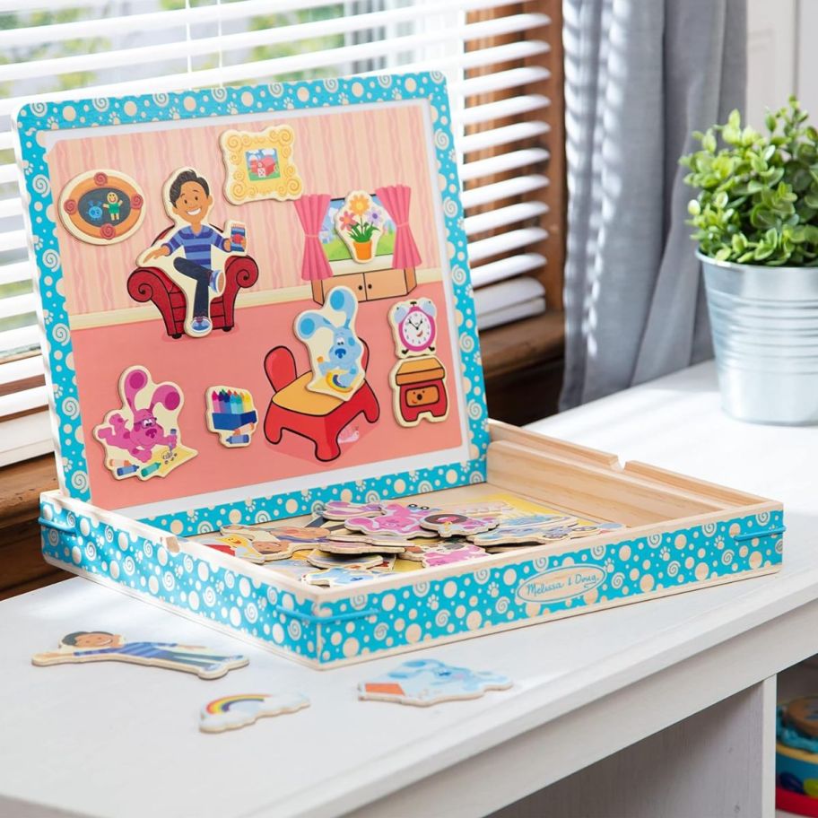 a magnetic puzzle game box sitting by a sunny window