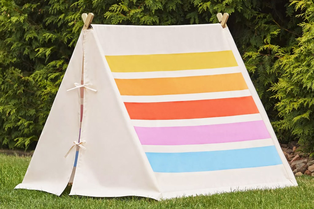 colorful striped outdoor play tent in grass