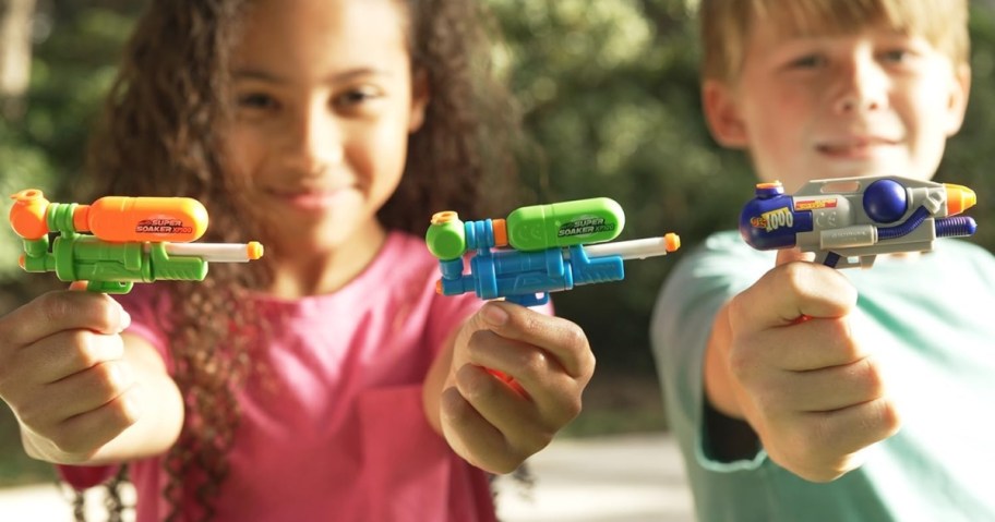 kids holding up keychain-sized nerf super soaker water guns