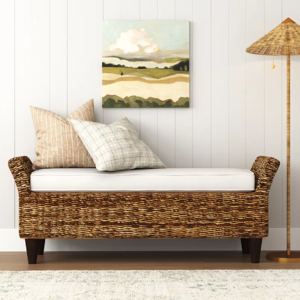 Elegant wicker bench with white cushion displayed in an entryway and available for purchase at the Wayfair Way Day event