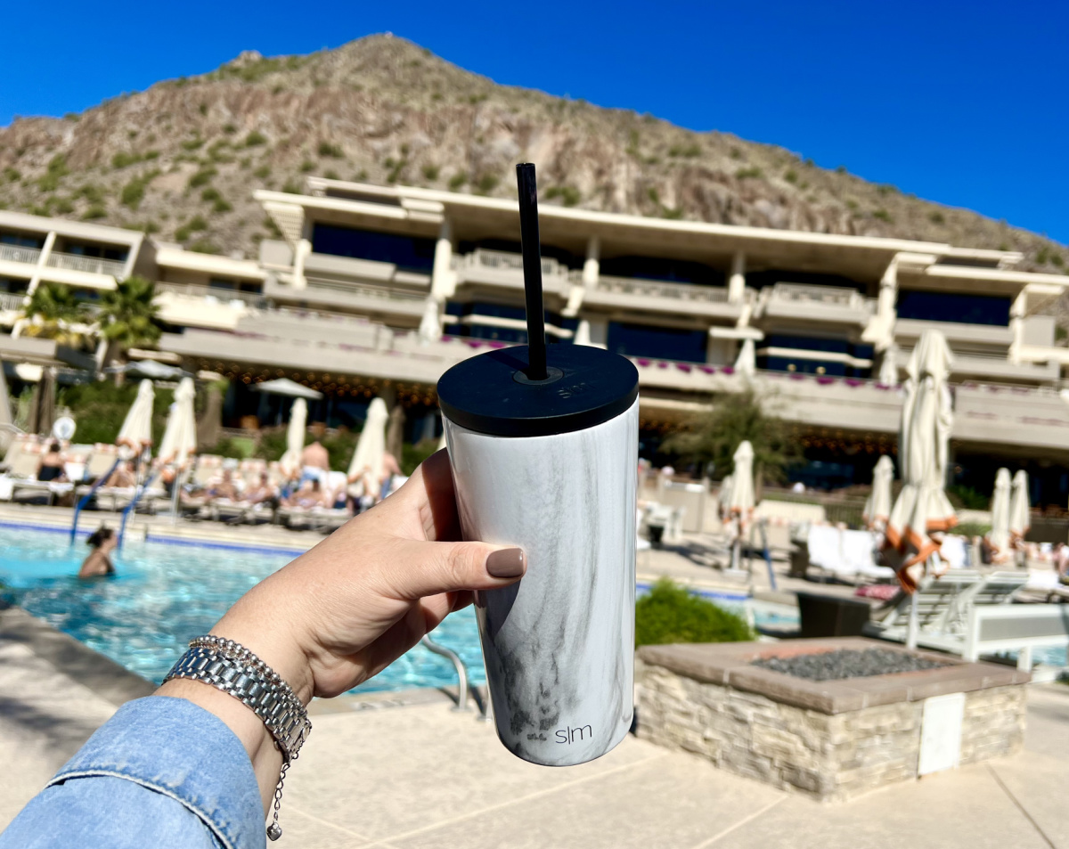 hand holding a Simple Modern Tumbler at the pool