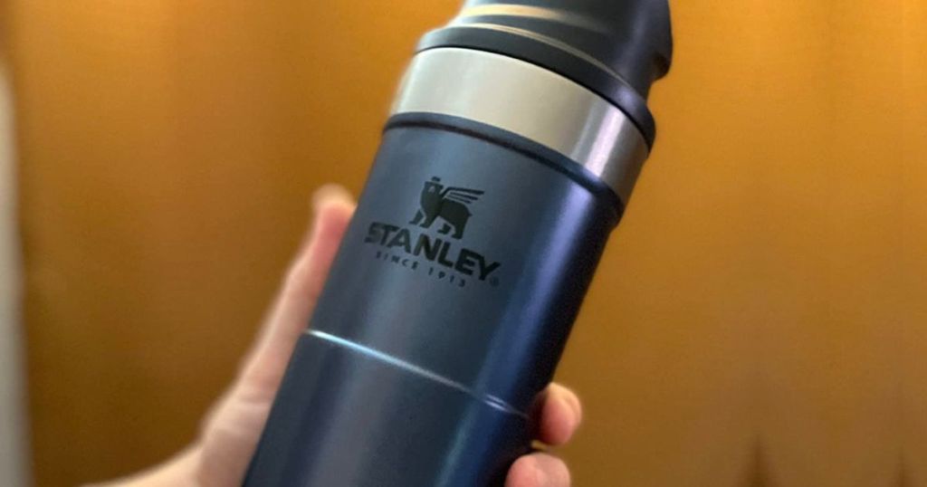 Close up view of a Stanley Tumbler in a hand