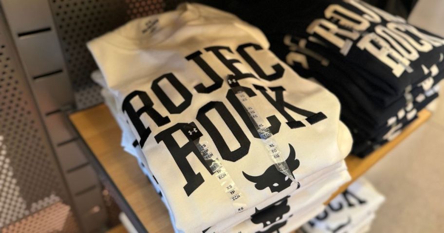A folded stack of Under Armour Project Rock T-Shirts