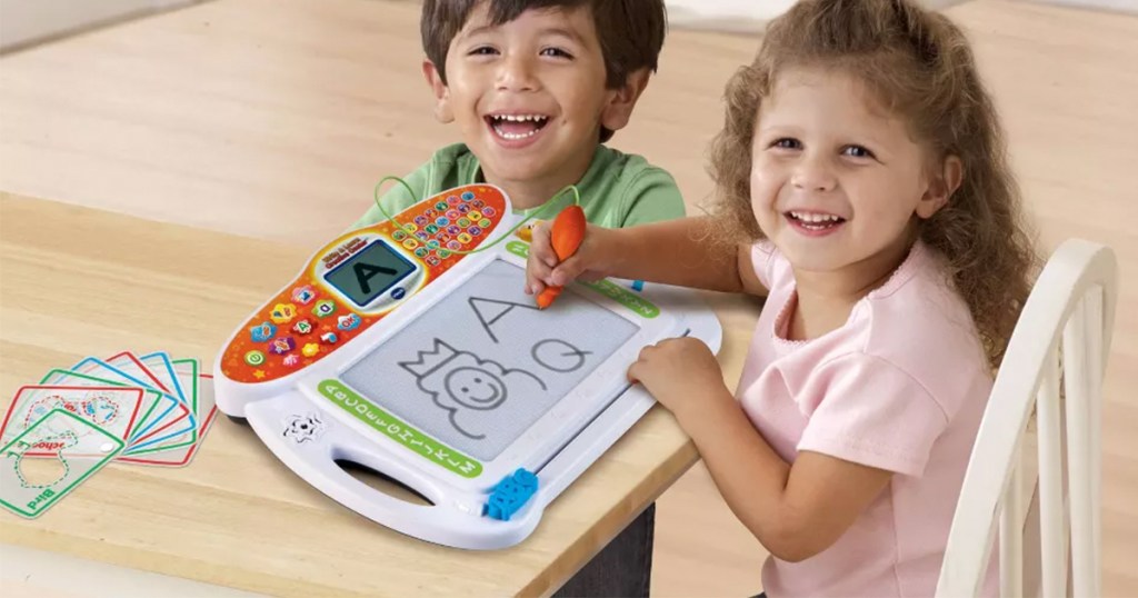 child with vtech write and learn creative toy