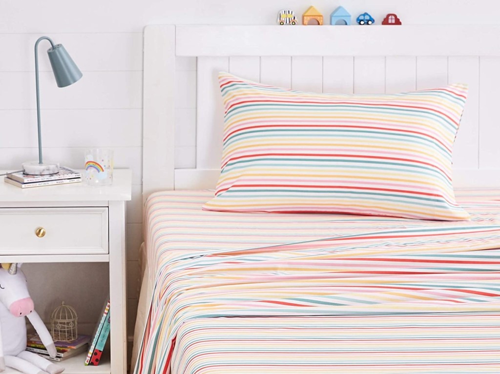 striped sheets on white children's bed