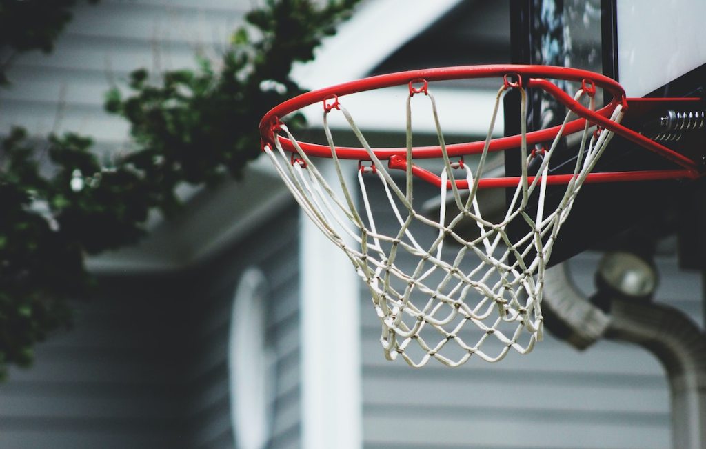 close up of basketball hoop outside by house