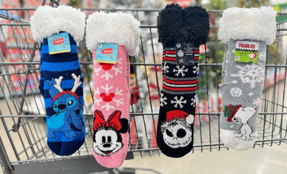 4 pair of disney slipper socks hanging on the sie of a shopping cart