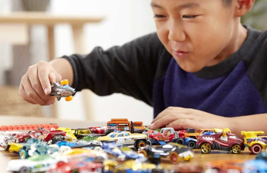 boy playing with hot wheels cars