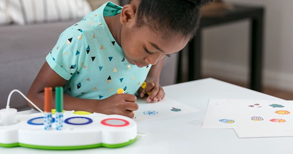 girl using Crayola light up stamper