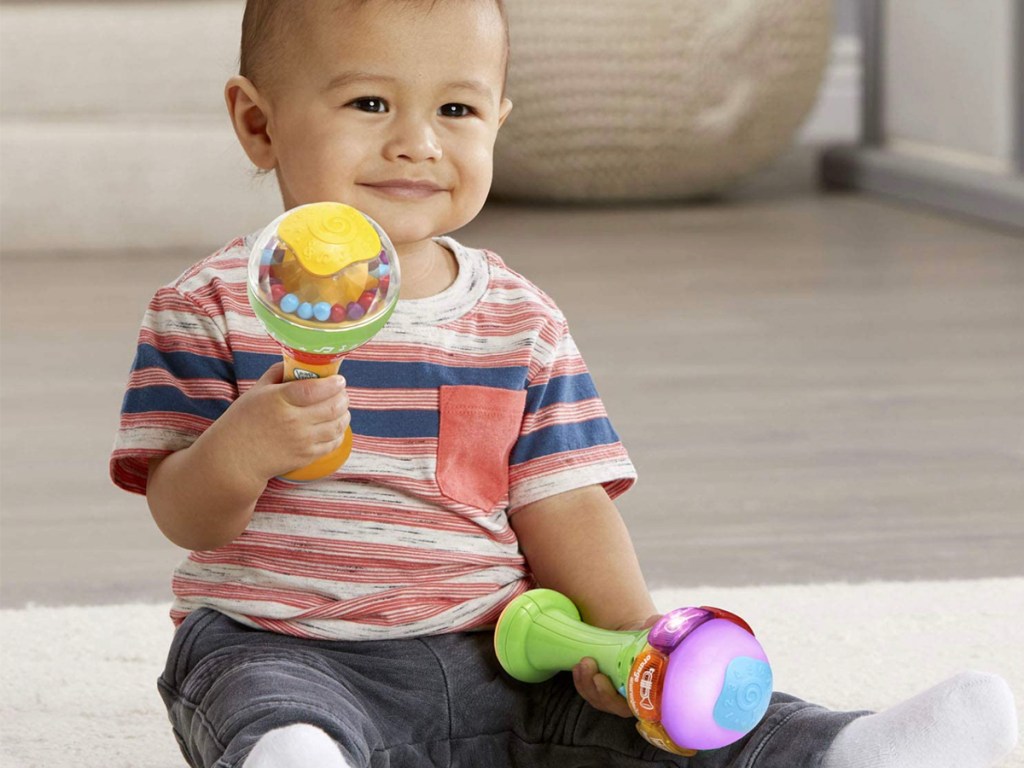 baby playing with leapfrog shakers