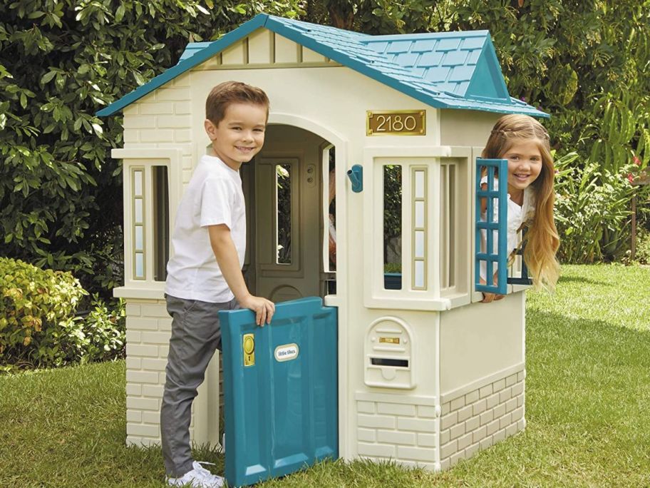 kids playing in a tan and blue Little Tikes Playhouse