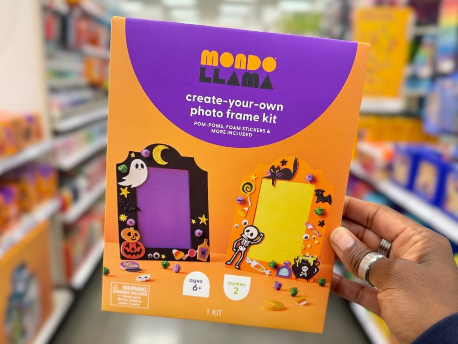 hand holding a paint your own Halloween Photo frame kit