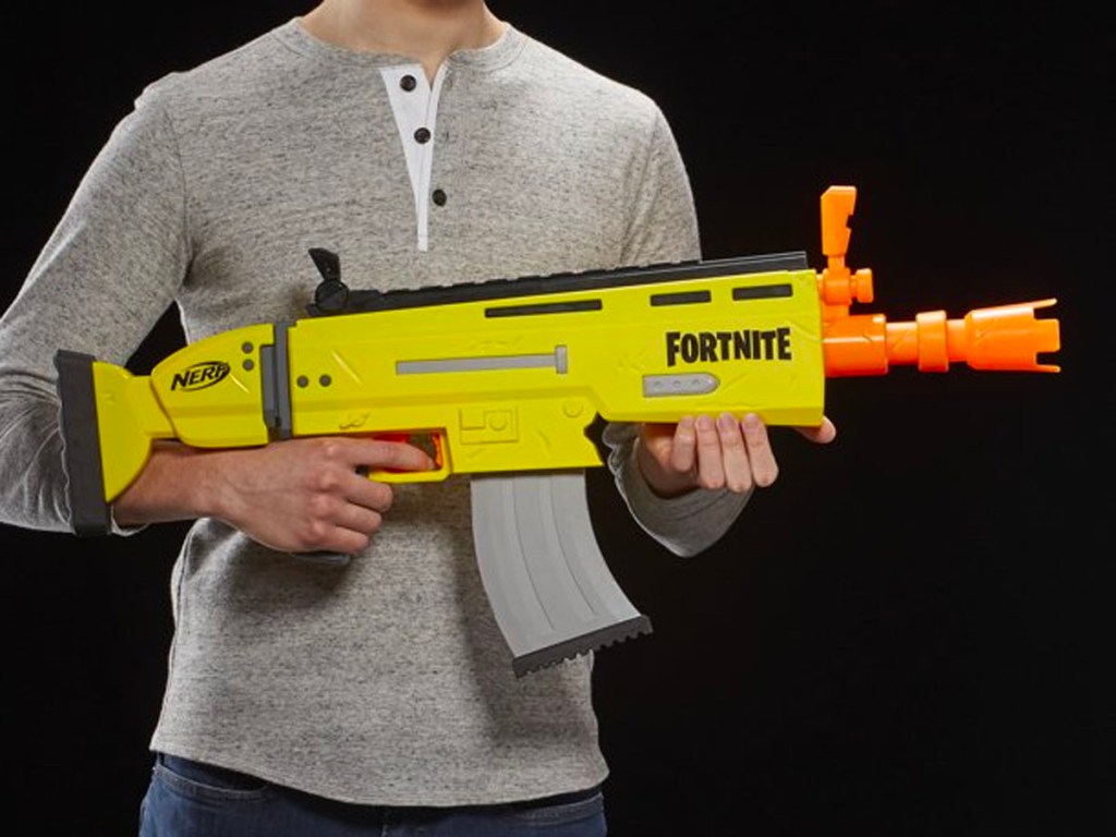 teen holding nerf fortnite blaster