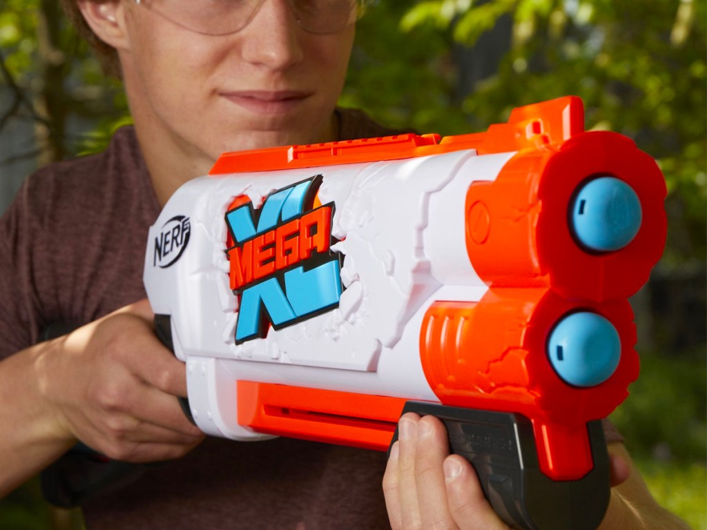 teen holding nerf mega xl double crusher blaster