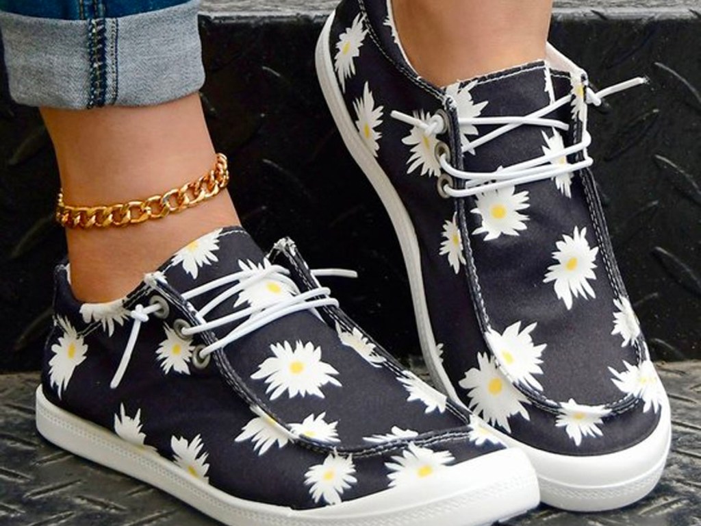 close up of woman wearing daisy boat shoes