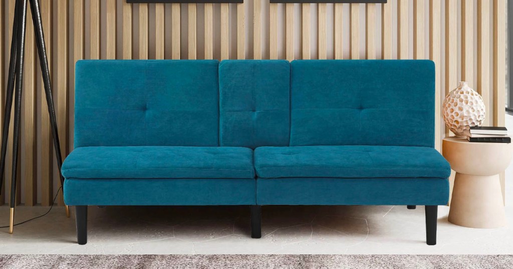 teal serta futon in living room