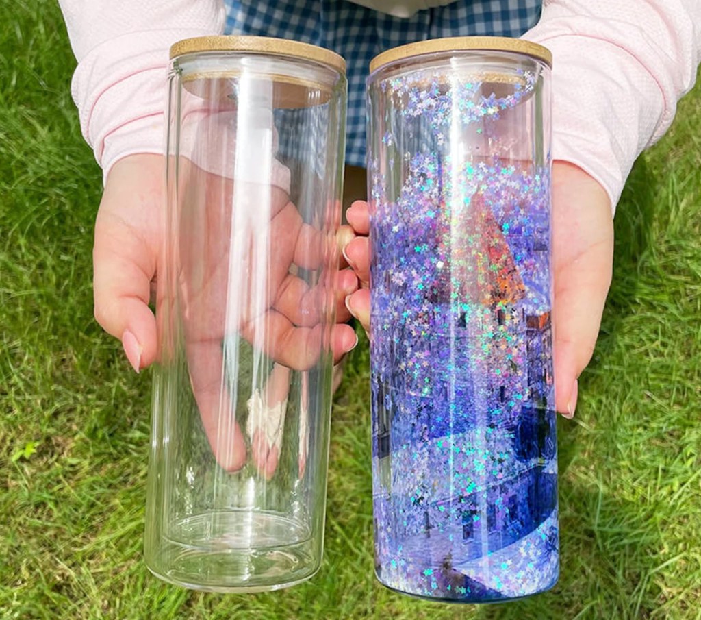 hands holding clear and snow globe glass tumblers coolest things on etsy
