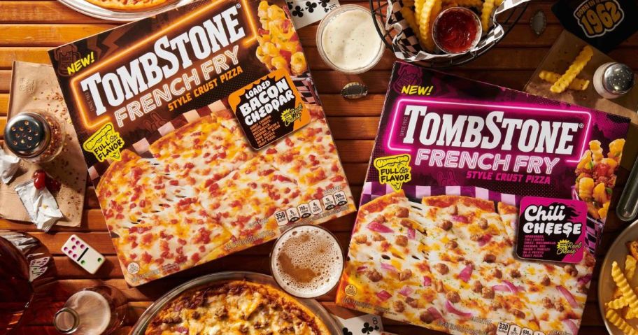 two tombstone fresh fry crust pizza boxes on tables with drinks and pizza around them