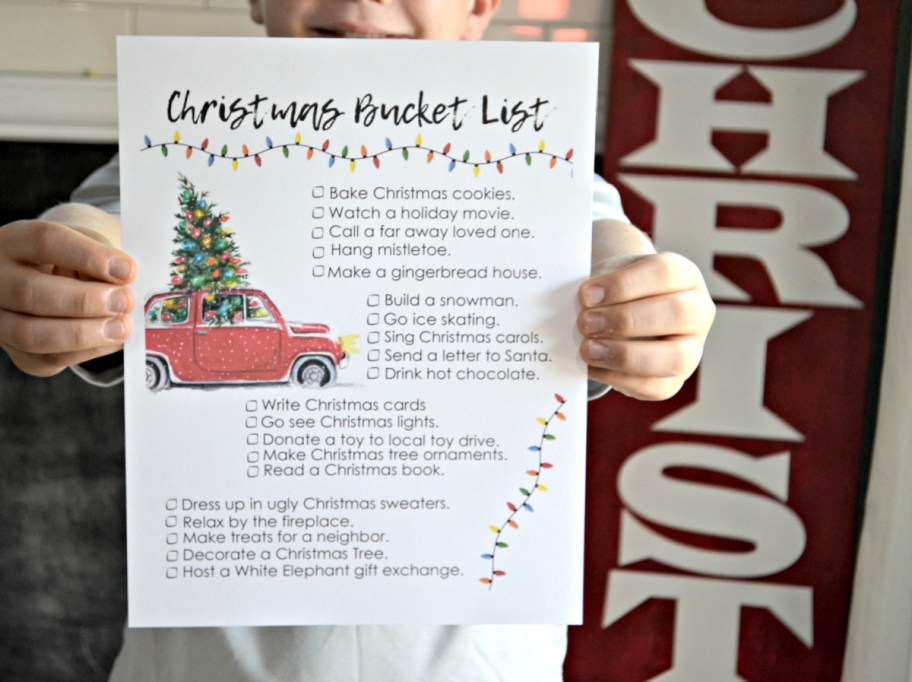 Child holding up a Christmas bucket list
