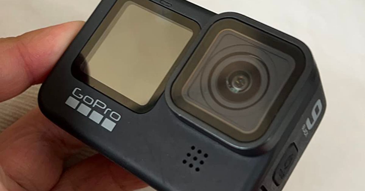 a man's hand holding a GoPro hero9 camera