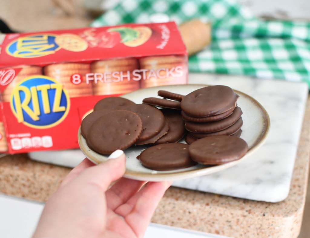 Hand holding a plate of homemade thin mints girl scout cookies