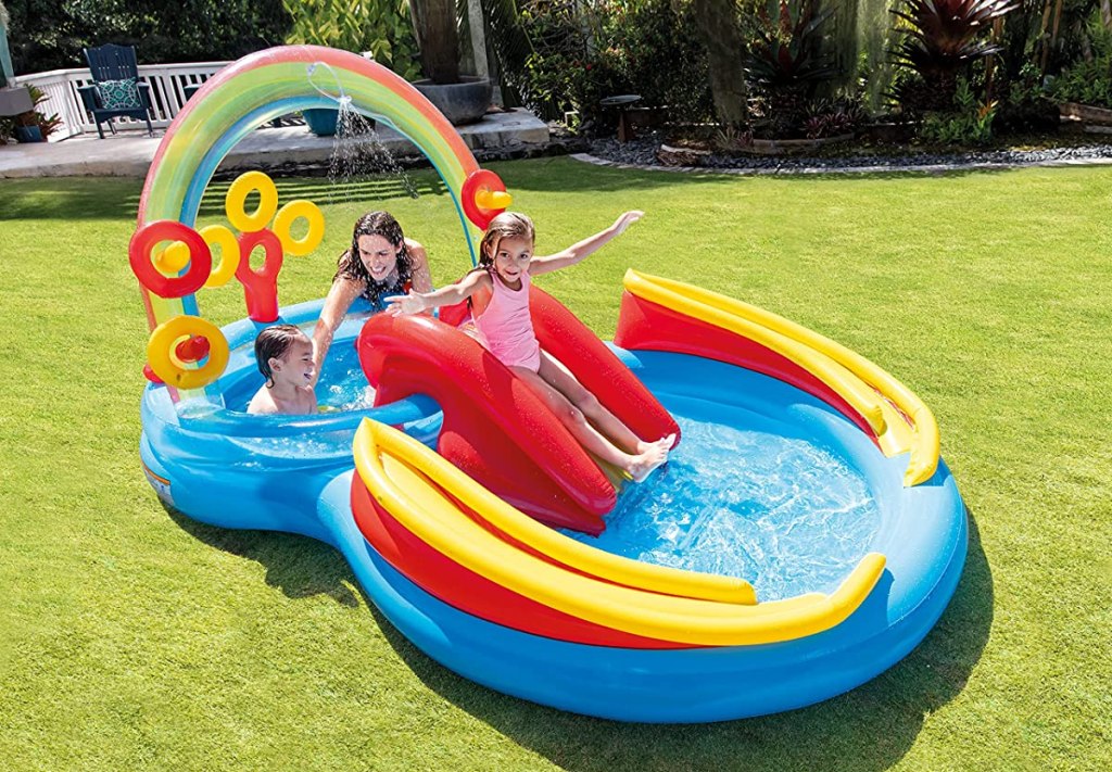 Kids playing on an inflatable pool and slide