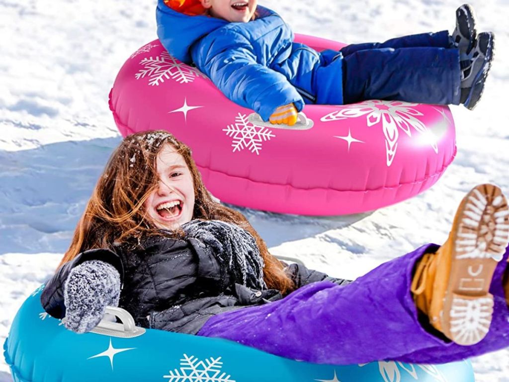 girl and boy on snow tubes