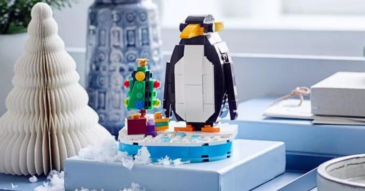 assembled LEGO Penguin sitting on a blue box near a white paper tree