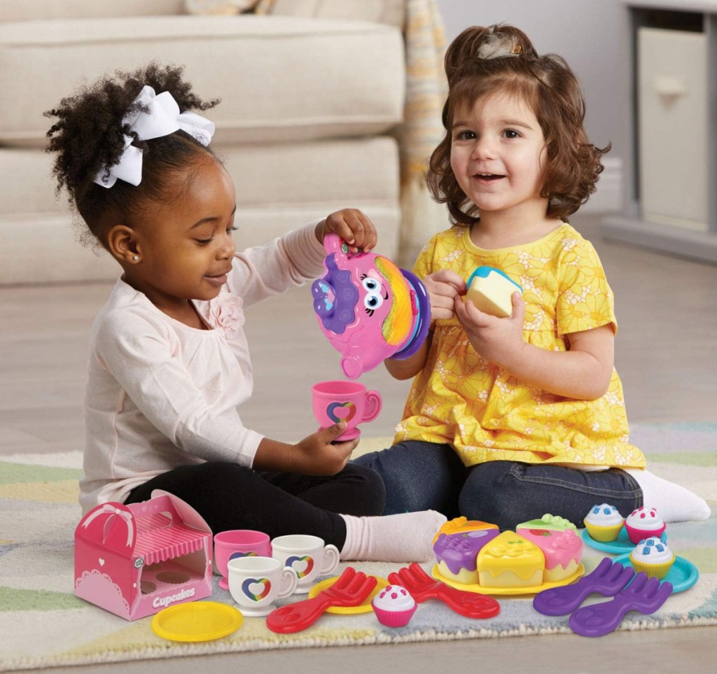 Two young girls playing with the LeapFrog Musical Rainbow Tea Party Deluxe