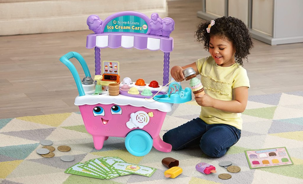 a girl using her LeapFrog Scoop and Learn Ice Cream Cart