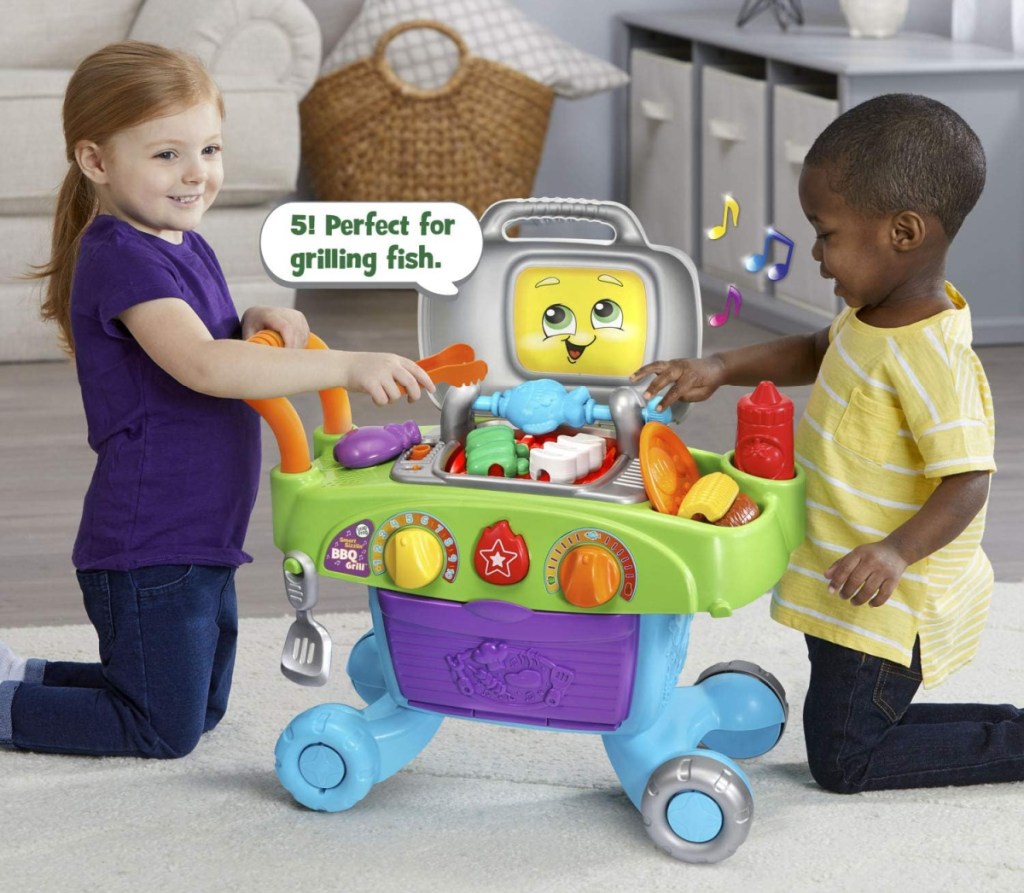 Two children playing with the LeapFrog Smart Sizzling BBQ Set