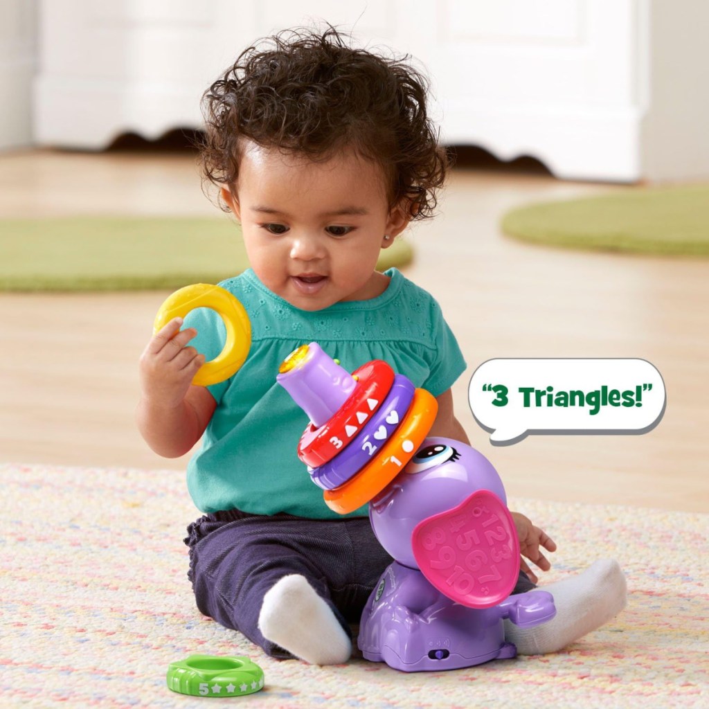 A baby playing with a LeapFrog Stack and Tumble Elephant