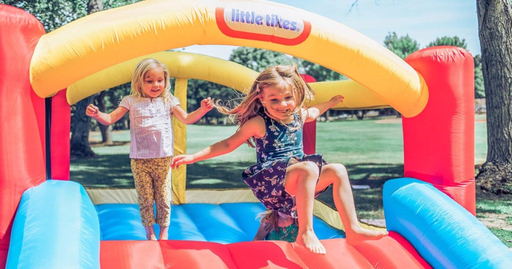 2 girls jumping on colorful little tikes bouncer