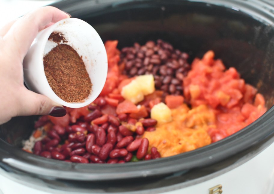 Adding spices to Pumpkin Chili