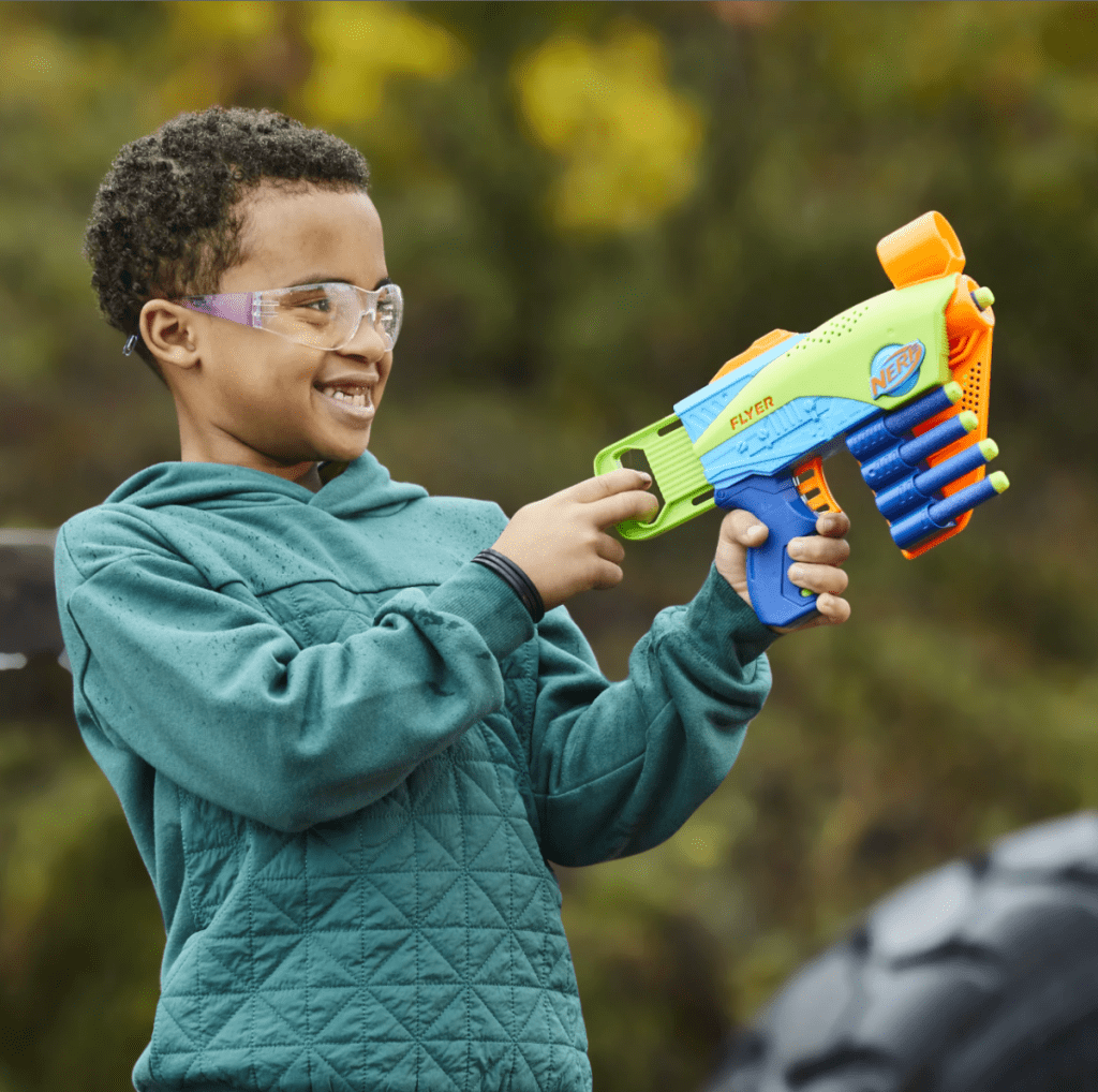 A Boy playing with the Nerf Elite Junior Flyer from Walmart's Top Toys List 2023