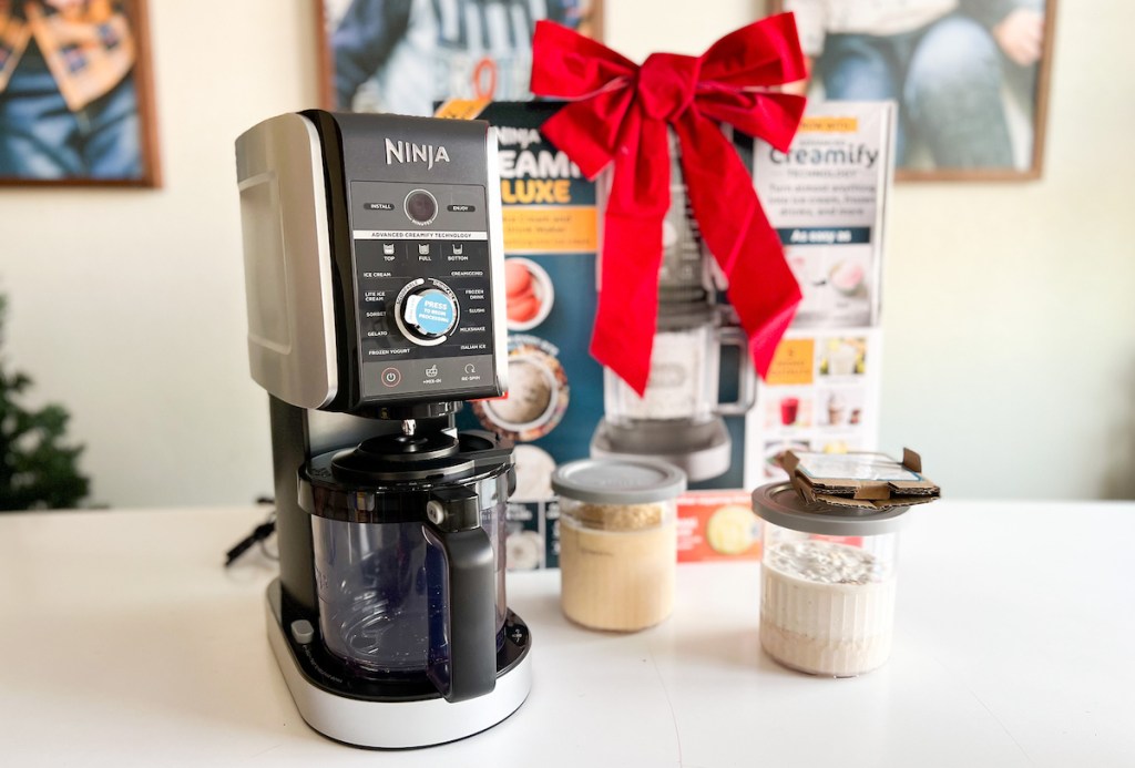 ninja CREAMi ice cream maker sitting on counter with big red bow