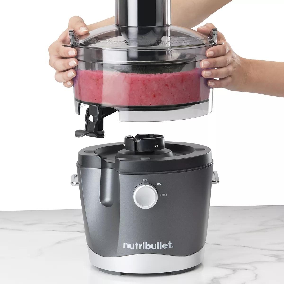 hand putting top on NutriBullet Juicer